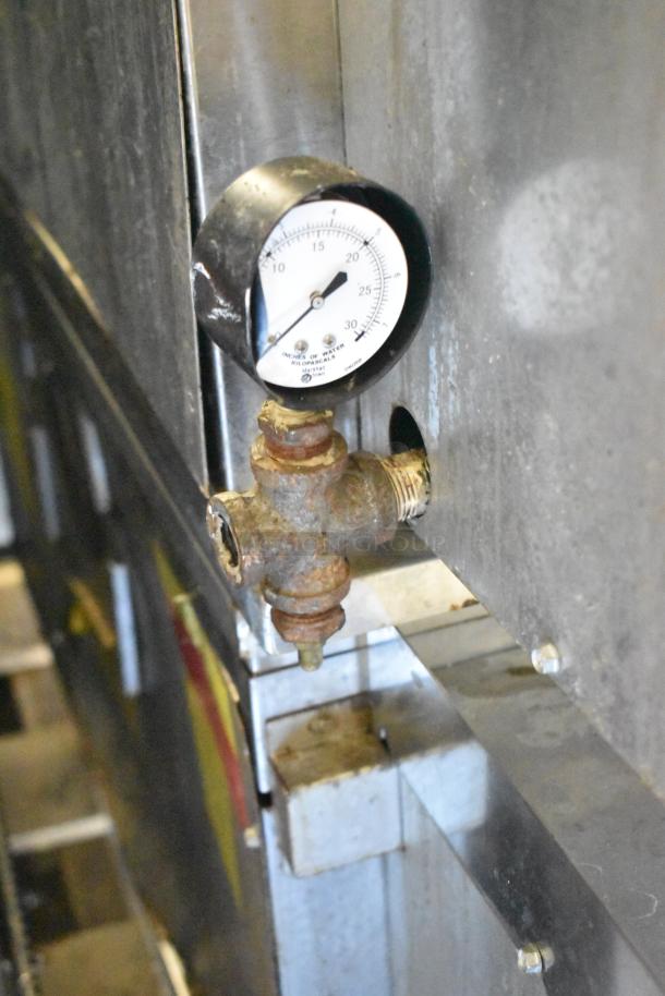 Close-up of a gauge on a Middleby Marshall PS638G pizza oven, indicating gas pressure in inches of water.