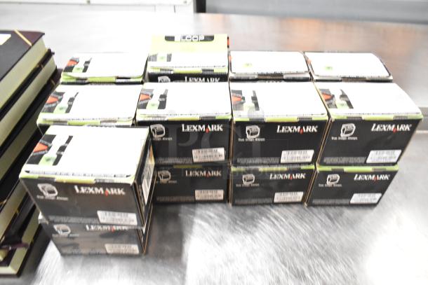 Lot of office supplies including Lexmark printer cartridges and notebooks. Approximately 25 items.