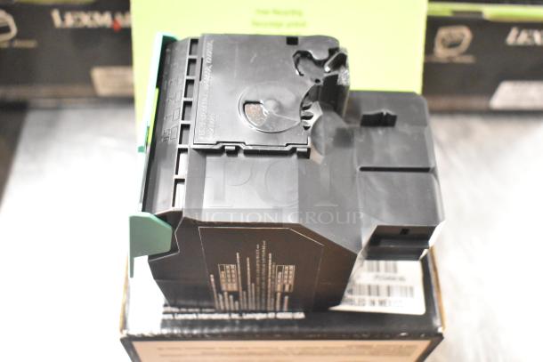 Lot of 25 items including notebooks, copy paper reams, Lexmark printer cartridge; good condition, ideal office supplies.