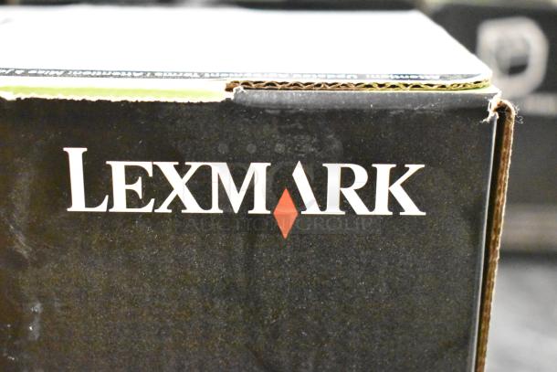 Lot of office supplies, including notebooks, copy paper, and a Lexmark printer cartridge in original packaging.