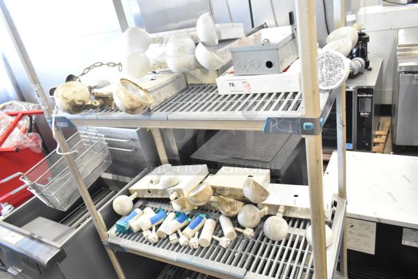 Auction items: emergency lights, exit sign, Eaton power box, assorted on shelves. Condition varies, some items worn.