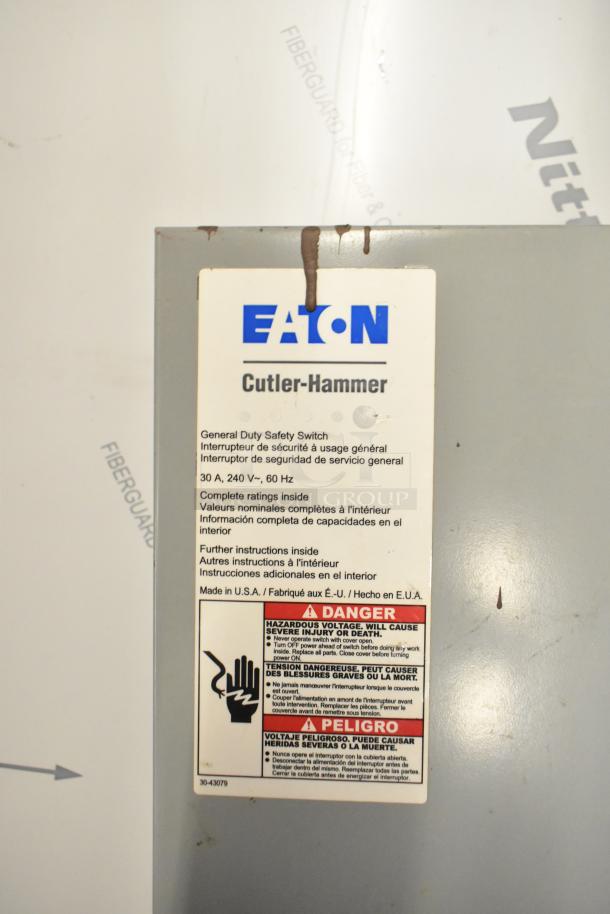 Eaton Cutler-Hammer power box, features general duty safety switch. Hazard warning label visible. Made in USA.