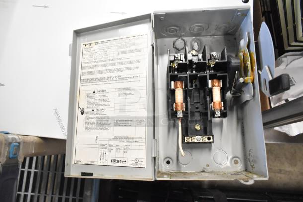 Eaton power box with interior wiring and safety instructions visible. Good condition. Includes emergency lights, exit sign.