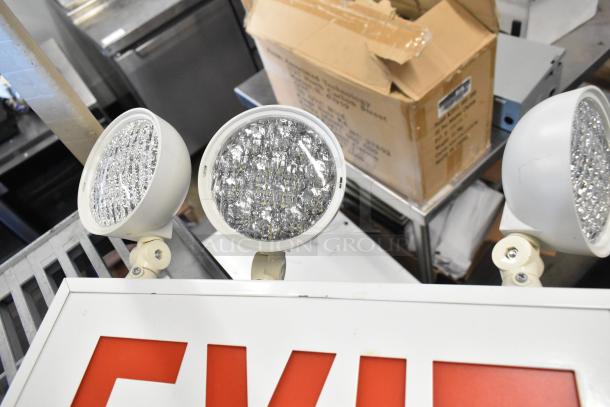 19-item auction lot including emergency lights, exit sign, and Eaton power box in good condition, with visible exit signage.