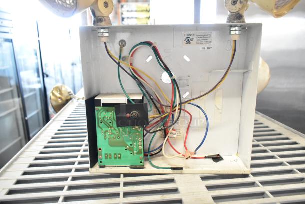 Emergency light system with exposed wiring, UL listed label, and green circuit board, part of a 19-item auction lot.