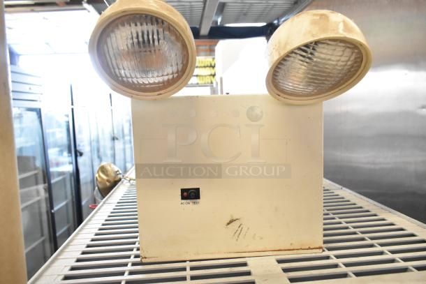 Emergency lights unit with dual lamps, visible on/off test switch, and signs of wear; part of a 19-item auction lot.