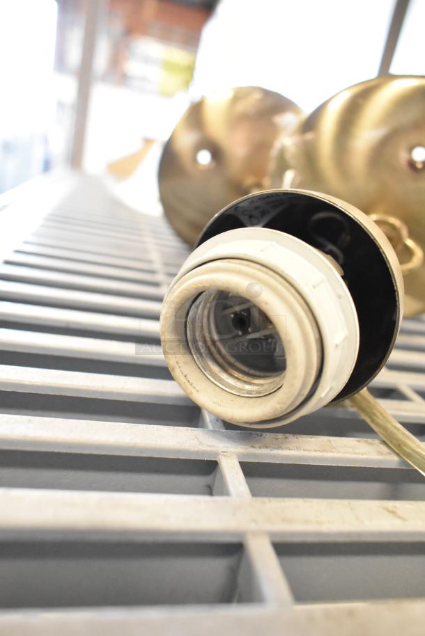 19 various items including emergency lights, exit sign, Eaton power box on metal shelf. Items show light wear.