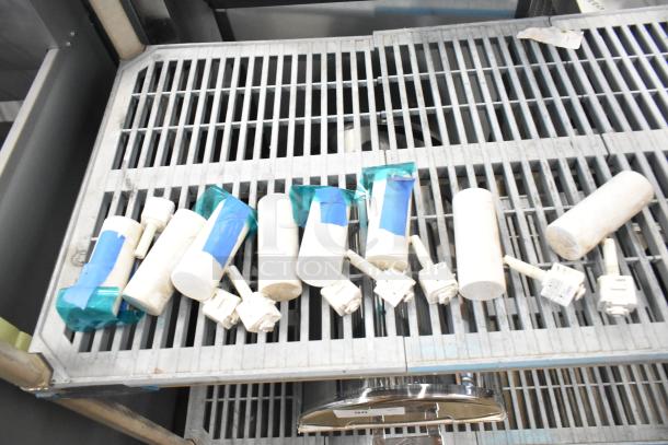 19 assorted electrical items including emergency lights and exit signs on a metal rack. Items appear used.