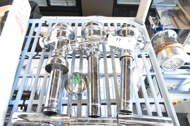 Three chrome flushing handles, new condition, with mounting hardware; tagged "77 Q7" on metal shelf.