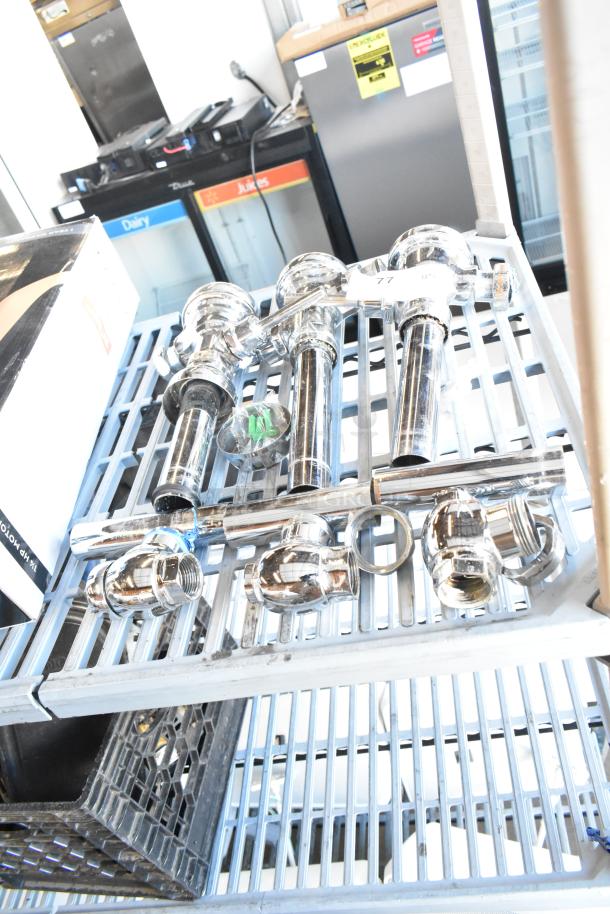 Set of 3 chrome flushing handles in new condition, displayed on a metal shelf. Includes mounting components.