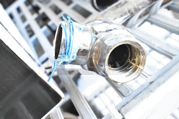 Chrome-plated plumbing fitting with blue thread sealant, potential flushing handle part; unclear condition.