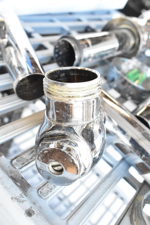 Chrome flushing handle, industrial design, showing moderate wear with visible threads and reflective finish on grill surface.