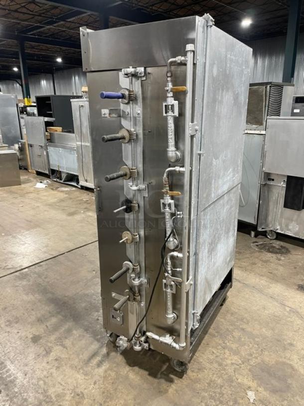 Attias stainless steel gas rotisserie cabinet on casters, full-height, multiple control knobs, commercial use.