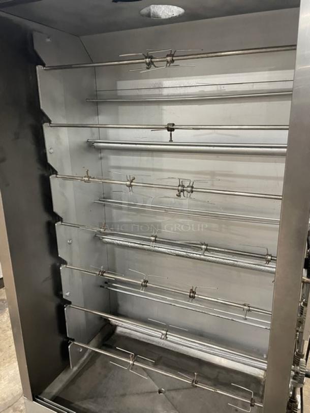 Attias commercial stainless steel gas-powered full-height rotisserie cabinet, on casters, with multiple skewers, excellent condition.