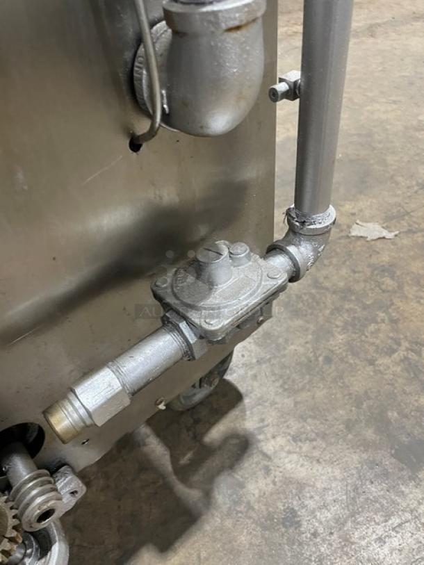 Attias stainless steel rotisserie cabinet, gas-powered, full-height, with casters; visible pipe fittings; used condition.