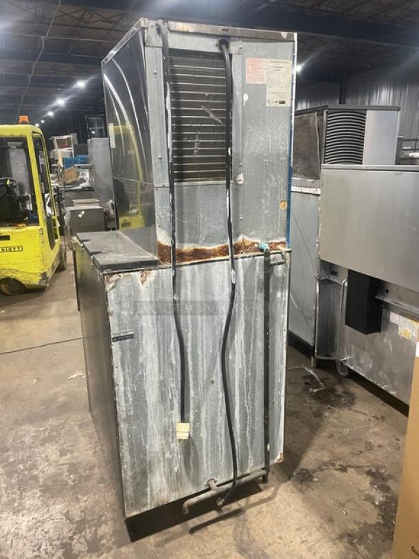 Hoshizaki KM-515MAH/B-500PF ice machine, stainless steel, electric, air-cooled, worn condition, on legs, visible wear and markings.