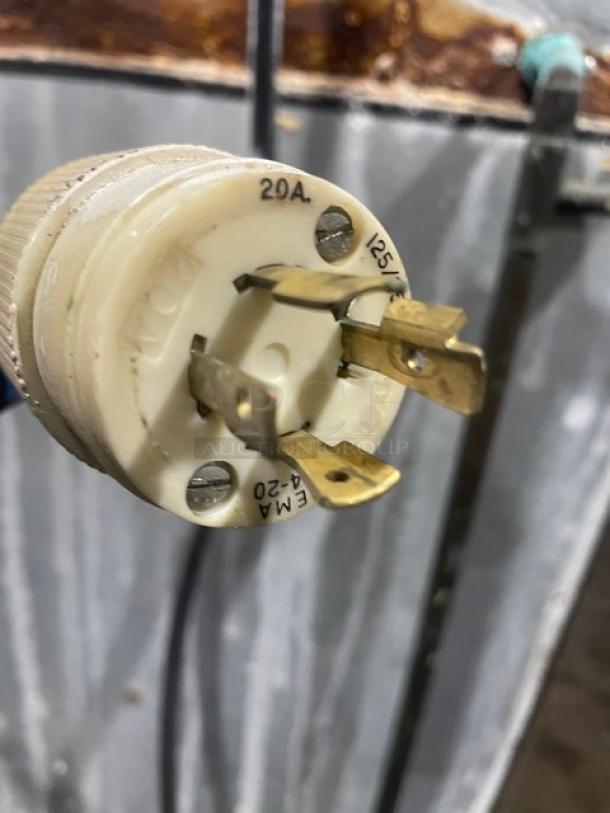 Hoshizaki ice machine power plug, 20A, 125V, showing prongs and voltage details, connected to stainless steel unit.