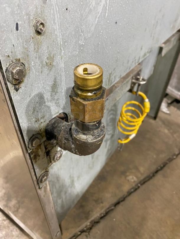 Asber gas-powered 6-burner range/oven combo with backsplash and overhead salamander shelf, showing gas connection detail.