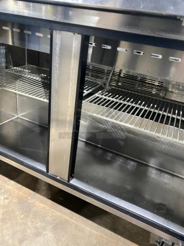 Turbo Air MST-48-N refrigerated prep table, stainless steel, 2 doors, poly-coated wired rack, on casters.