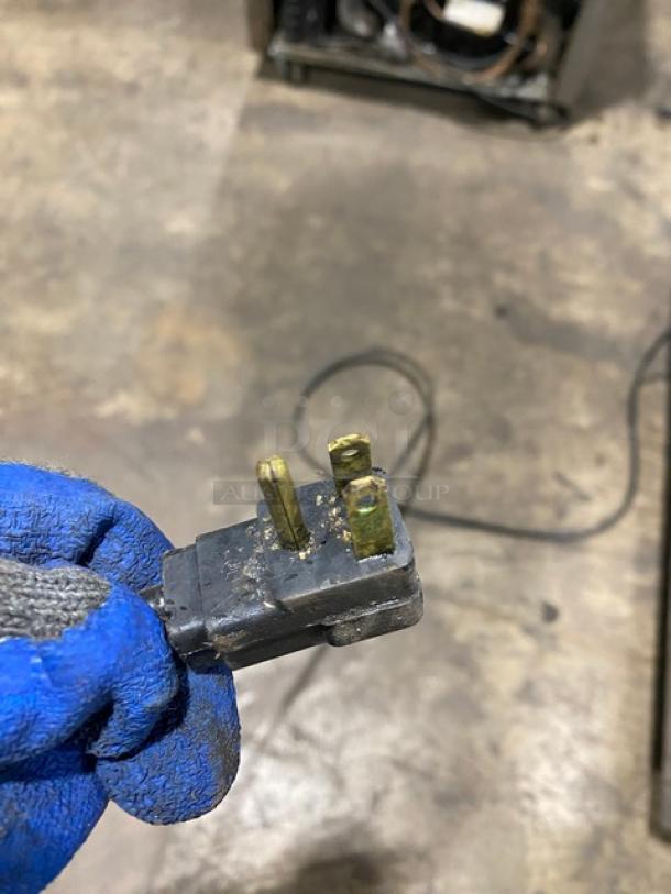 Close-up of a power plug, showing wear, for Beverage-Air Commercial Stainless Steel 2 Drawer Refrigerated 36" Chef Base.