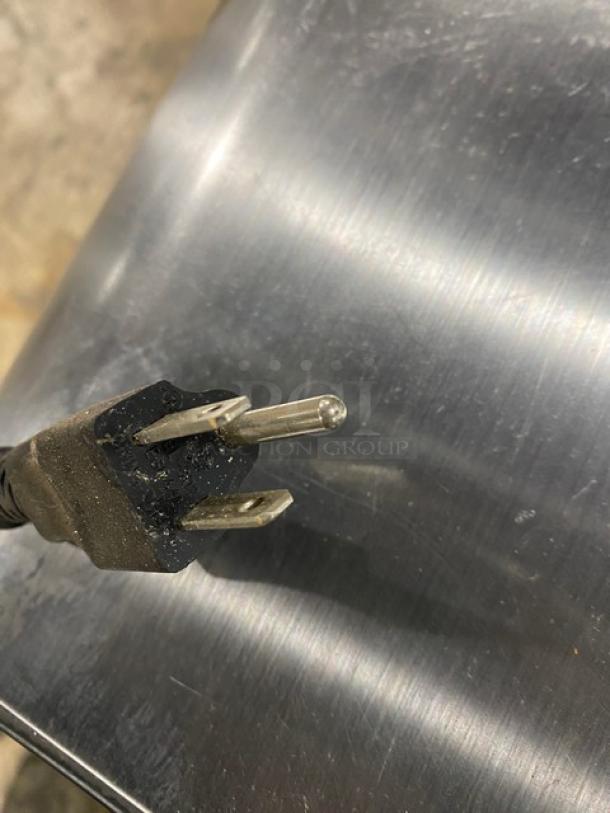 Plug of Twothousand stainless steel bread slicer, Model TTD7B, 110V, shows slight wear. High-efficiency countertop slicer.