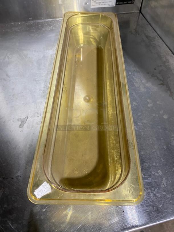 NEW Cambro amber high-heat half-size food pan, 4" deep, in pristine condition. Ideal for commercial kitchen use.