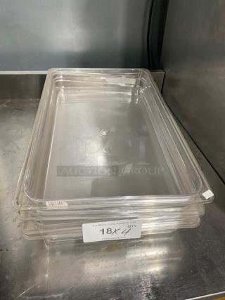 Cambro clear polycarbonate full-size food pan, 2.5" deep, new condition, stack of four, auction label visible.