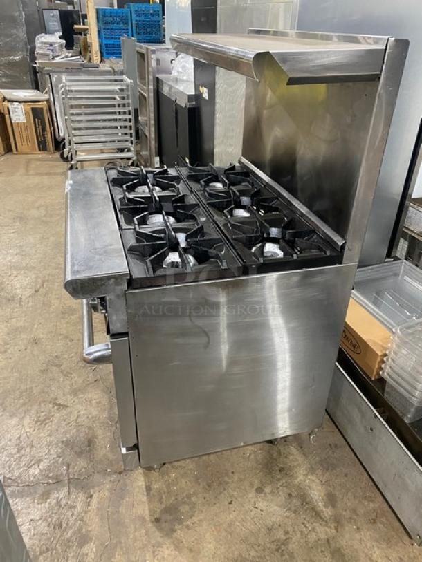 American Range 6-burner stainless steel gas range/oven combo with backsplash, overhead salamander shelf, and wired oven rack.