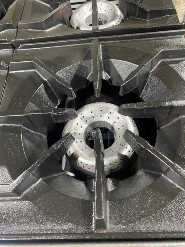 American Range stainless steel 6-burner gas range/oven, featuring overhead salamander shelf and wired oven rack, in excellent condition.