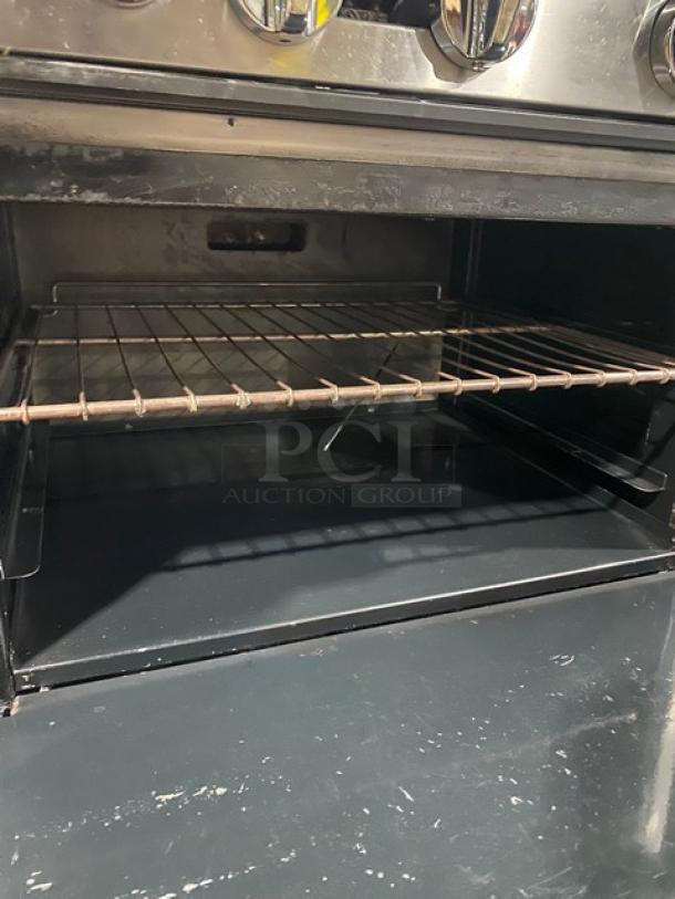 American Range commercial stainless steel gas 6-burner range/oven combo with backsplash, overhead salamander shelf, and wired rack.