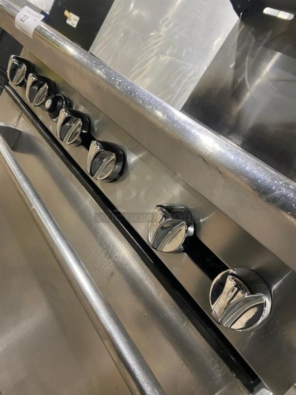 American Range commercial stainless steel 6-burner gas oven with backsplash, overhead salamander shelf, and wired oven rack.