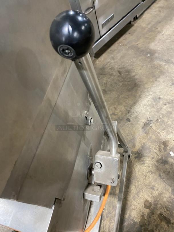 Jaccard E93 commercial meat tenderizer with stainless steel construction, electric powered, open base, and casters.