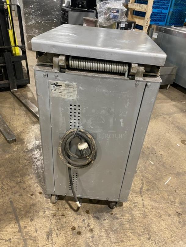 Panimatic P84S commercial dough divider in used condition. Features electric power, free-standing design, and casters. Visible wear on exterior. Serial number 025S225 on tag.
