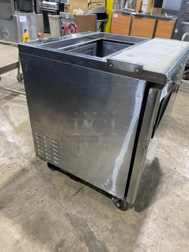 Turbo Air TST-28SD refrigerated prep table; stainless steel; single door; cutting board; on casters; 115V; commercial use.