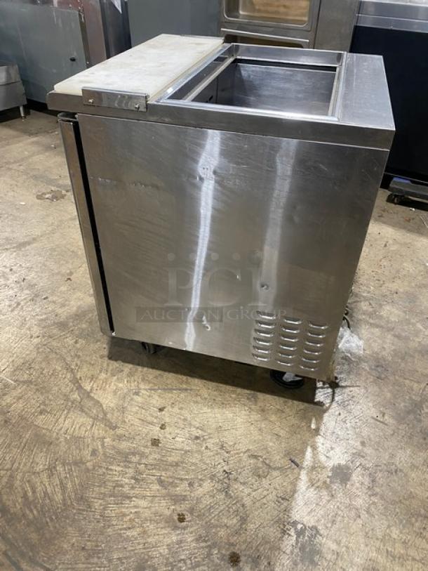 Turbo Air TST-28SD refrigerated prep table, stainless steel, single door, with cutting board, on casters.