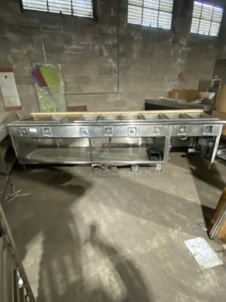 Wells stainless steel 8-well hot food steamtable, electric-powered, individual controls, single undershelf, on legs.