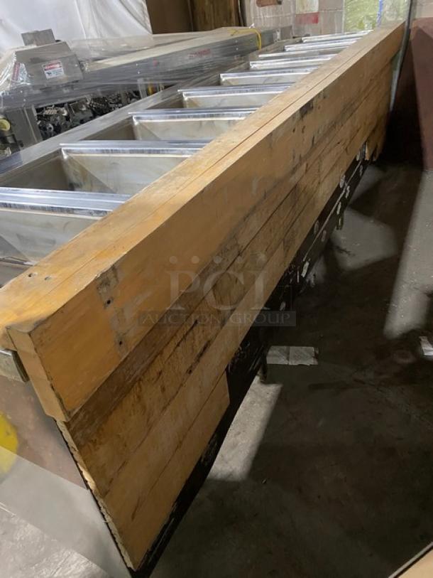 Wells commercial stainless steel 8-well steam table, electric-powered, with individual controls, undershelf, on legs.