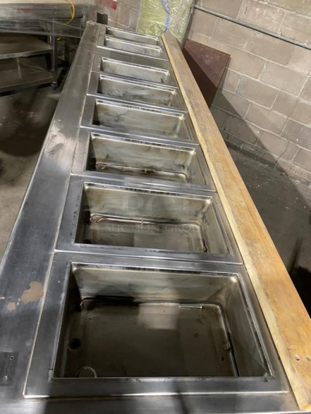Wells stainless steel 8-well hot food steam table, electric powered, individual controls, single undershelf, on legs.