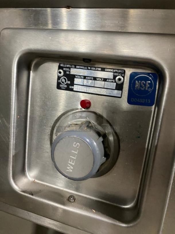 Wells stainless steel 8-well hot food steamtable control panel, featuring individual temperature controls and NSF certification.