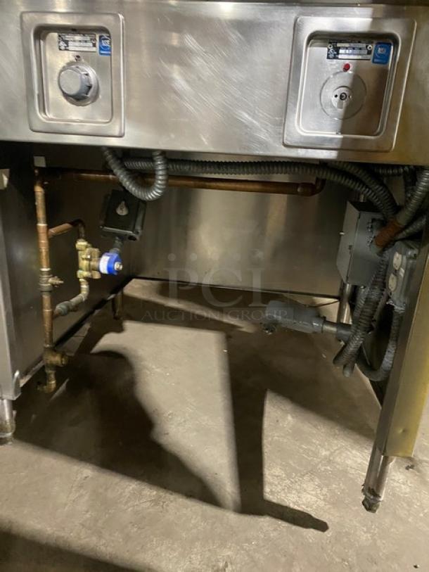 Wells commercial stainless steel 8-well hot food steam table, individual controls, single undershelf, on legs, electric powered.