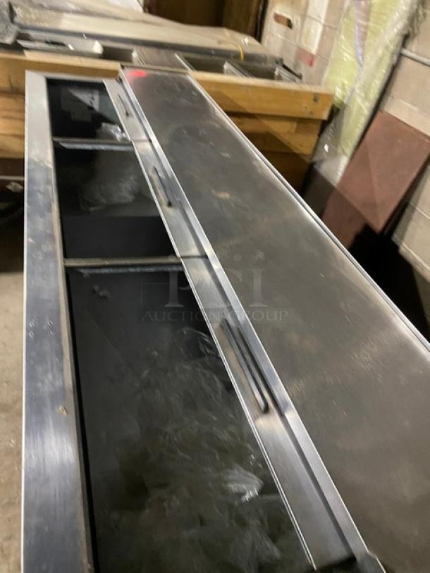 Beverage-Air DW79B deep well bottle cooler with stainless steel worktop, sliding lid, and black exterior. Model DW79-B, 115V, used.