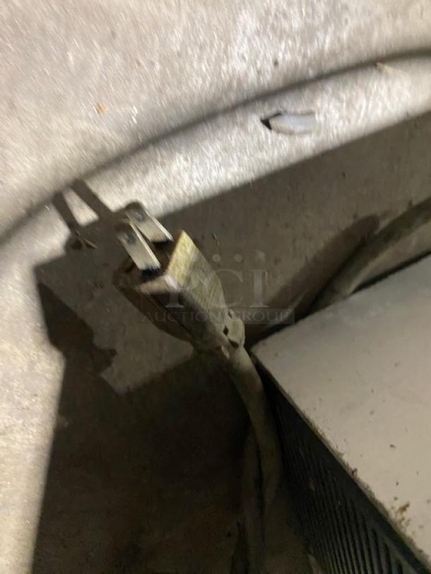 Hobart commercial electric food processor plug and cord in used condition on concrete surface.