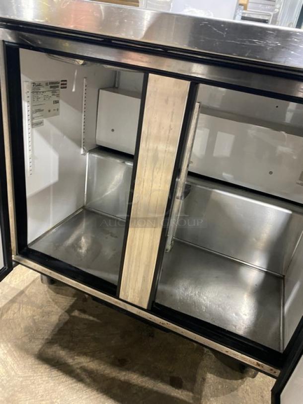 True 2-door stainless steel refrigerated prep table, model TSSU-36-12M-B, on casters. Includes hotel/steamtable pan.