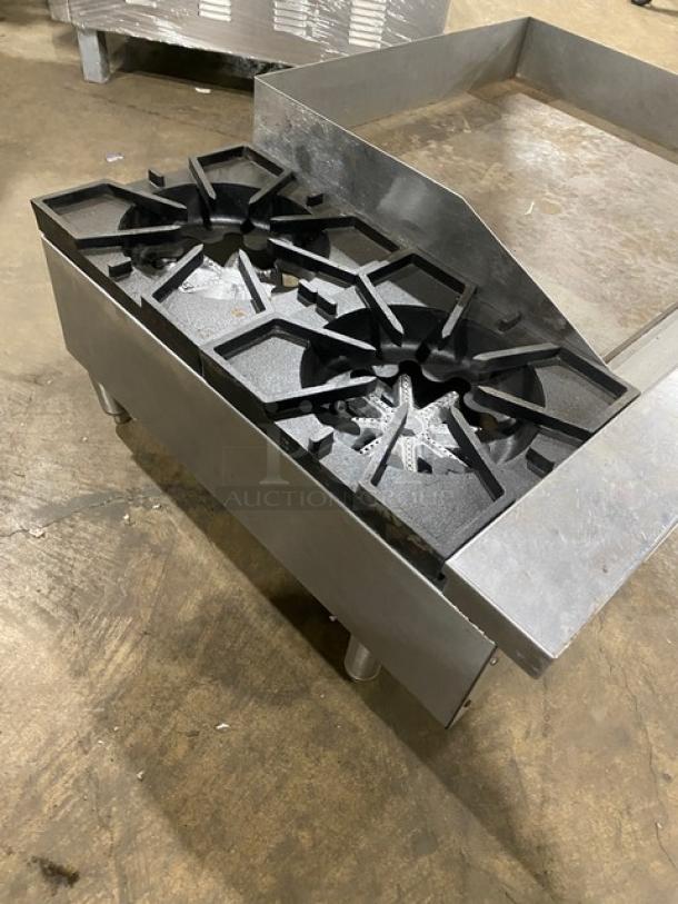 Comstock-Castle stainless steel 2-burner split top flat griddle range, model FHP3624. Features griddle back, side splash, and legs.