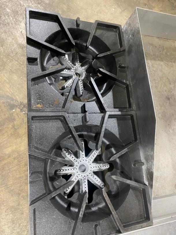 Comstock-Castle 2-burner cast iron griddle with griddle back and side splash, Model FHP3624, in used condition.