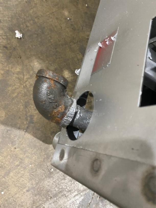 Comstock-Castle Model FHP3624 stainless steel flat griddle range, natural gas, with rust on gas pipe, back, and side splash.