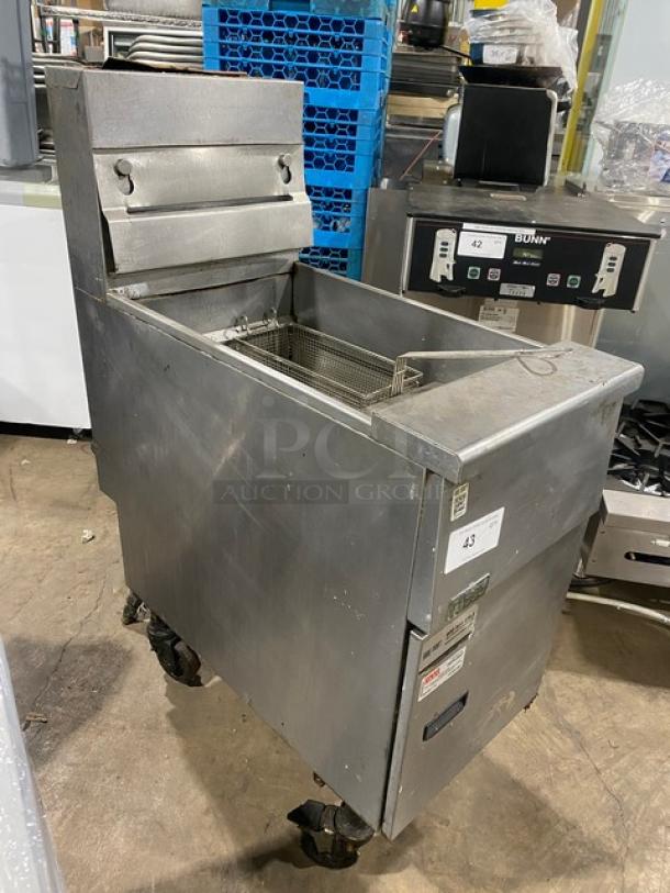 Pitco VF35 stainless steel natural gas deep fryer, 35 lb. capacity, with backsplash, basket hanger, and fry basket, on casters.