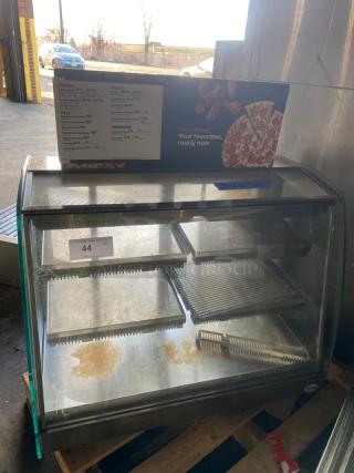 Vendo stainless steel heated food merchandiser with slanted glass, multi-tier shelves, rear sliding doors, 115V, used condition.