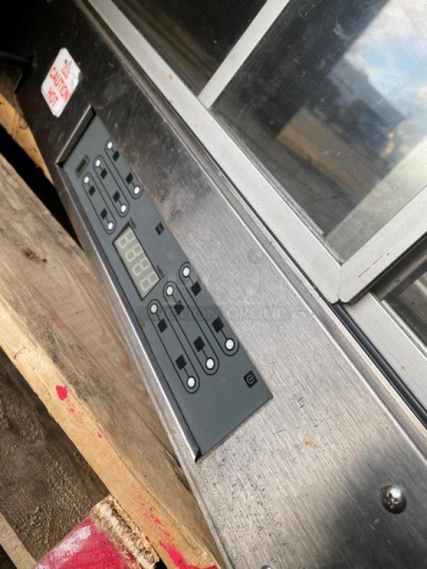 Vendo stainless steel hot food merchandiser with slanted glass and digital control panel, featuring rear sliding doors.