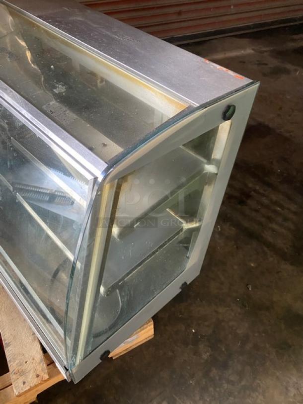 Vendo stainless steel countertop heated food merchandiser with slanted glass, multi-tier, rear sliding doors, 115V, good condition.